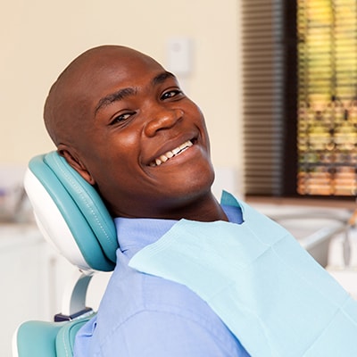 A-man-sitting-in-the-dentists-chair-smiling- Tumwater Dentist Office